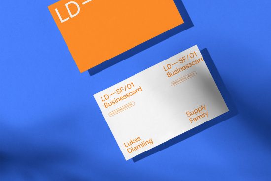 Business card mockup with minimal design, orange and white cards on a blue background. Ideal for presenting branding and identity designs.