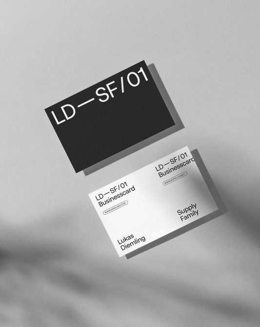 Black business card with white text stacked over white card mockup