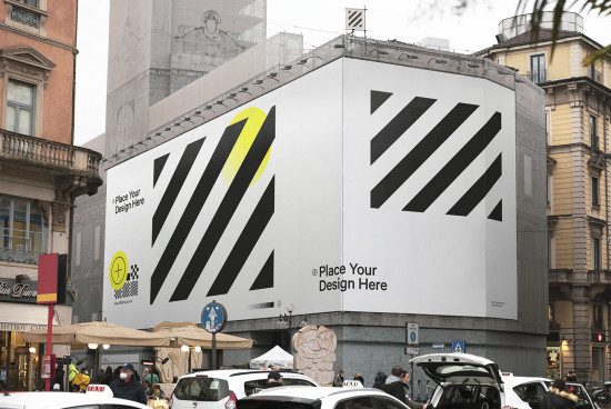 Urban billboard mockup on a city building exterior for designers to showcase advertising designs, placed in a busy street setting.