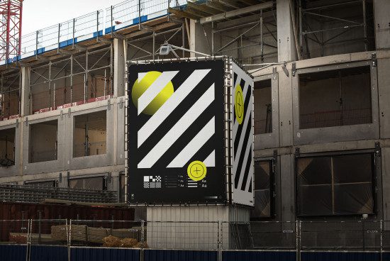 Billboard mockup on a construction site displaying a bold graphic design with yellow accents, ideal for presenting outdoor advertising designs.