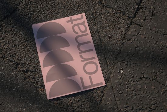 Mockup of a pink brochure with modern typography design on a textured asphalt background, ideal for showcasing graphic designs.