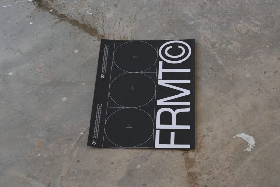 Magazine mockup lying on a textured concrete floor showcasing modern font and geometric graphic design, ideal for presentations and portfolios.