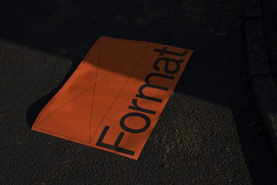 Realistic orange poster mockup on ground with dramatic shadows for design presentation, street marketing visuals, urban advertising content.