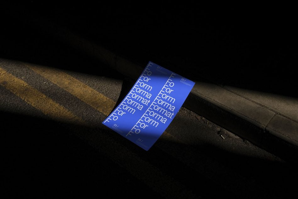 Blue publication with white typography laid on dark industrial ground surface