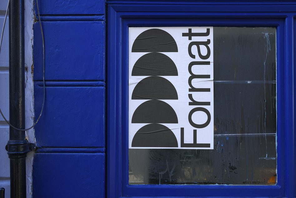 Blue storefront window showcasing a black and white geometric Font design poster, ideal for Mockups and Typography inspiration.