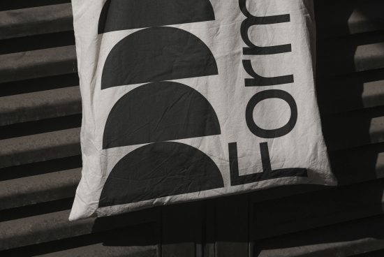 Close-up view of a bold typographic design on fabric with shadow play, ideal for mockup and graphic design inspiration.