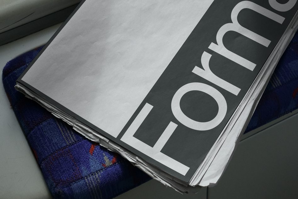 Print magazine mockup on a blue textile surface, angled view showcasing design space, ideal for graphic presentation.