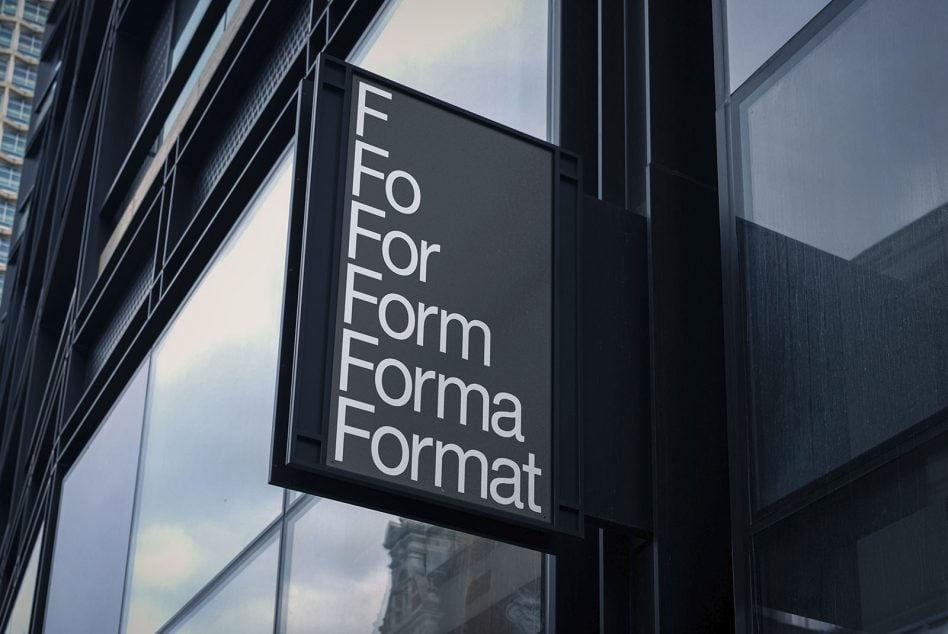 Modern building facade with black square sign showing white text For Form Forma Format