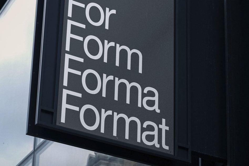 Dark storefront sign with white sans-serif text reading For Form Forma Format