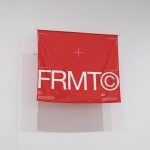 Red poster mockup hanging on wall with modern typography design, ideal for showcasing graphic designs and fonts.