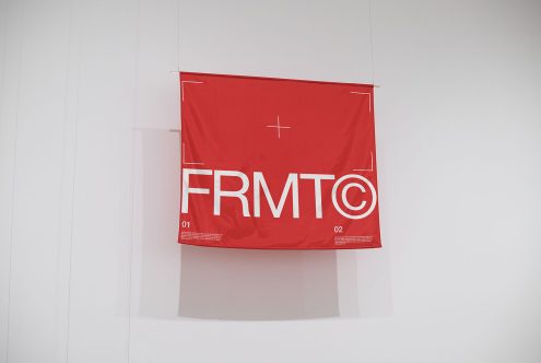 Red poster mockup hanging on wall with modern typography design, ideal for showcasing graphic designs and fonts.