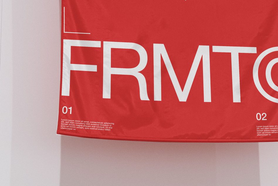 Red fabric banner with bold white FRMT text on white wall backdrop
