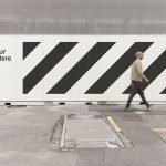 Outdoor billboard mockup template with editable design space, featuring a pedestrian for scale, ideal for advertising and urban design presentations.