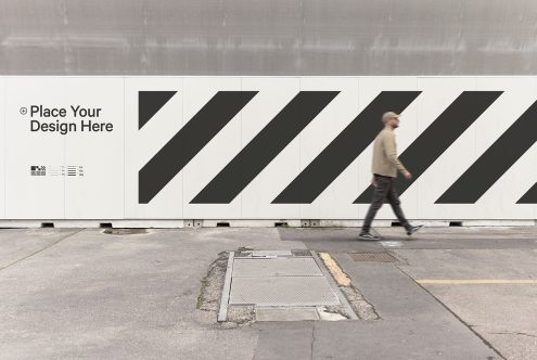 Outdoor billboard mockup template with editable design space, featuring a pedestrian for scale, ideal for advertising and urban design presentations.