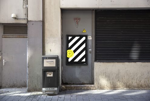 Urban scene with modern street signage mockup on a textured door, shadows play, perfect for presenting designs to clients.