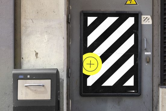 Urban electrical box with black and white stripes and yellow plus sign, realistic mockup for branding in a city setting.