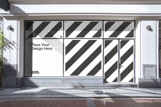 Storefront window mockup with placeholder text for showcasing design, against an urban background, perfect for designers' template display.