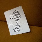 A4 paper mockup with typographic design, resting on a textured brown couch, ideal for presenting print templates and fonts to designers.