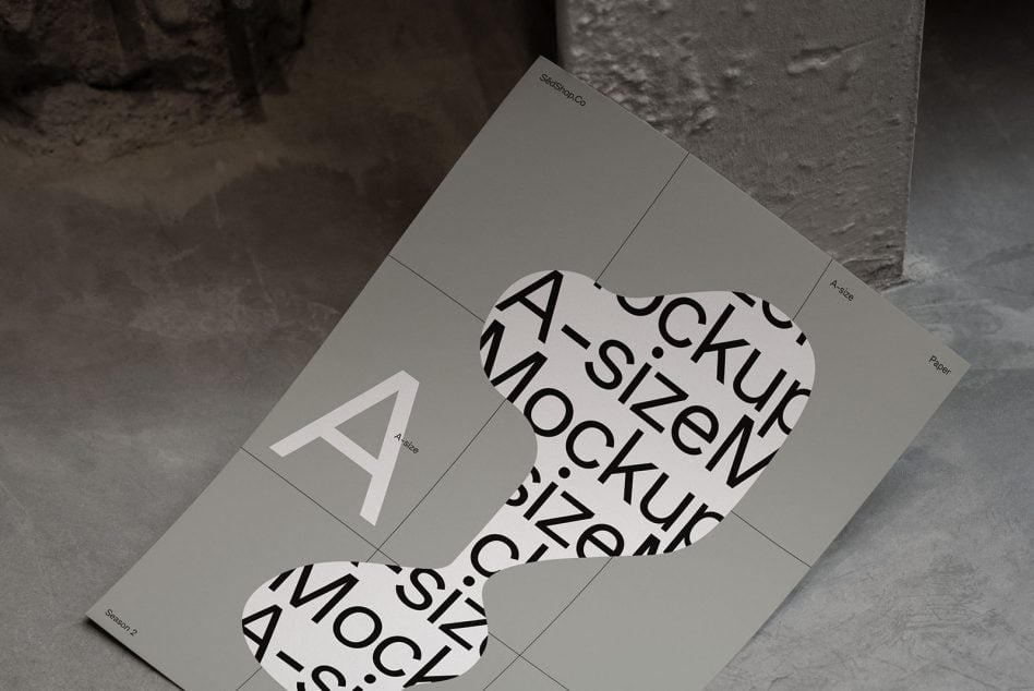Overhead shot of bent A-size papers on raw concrete with shadows