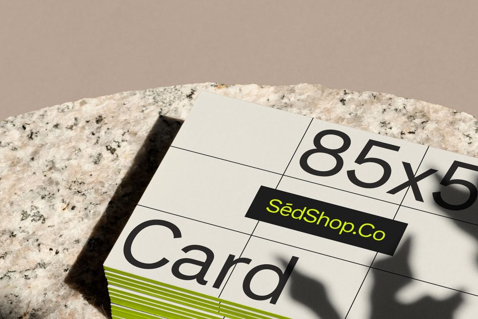 Business cards fanned out on terrazzo stone with bright sunlight casting shadows