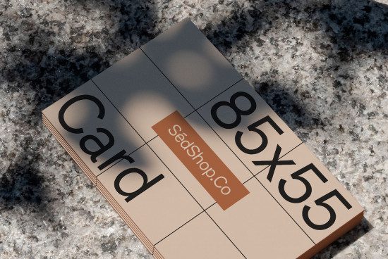 Stack of business cards mockup on a granite texture surface with elegant shadows, ideal for realistic branding design presentations.