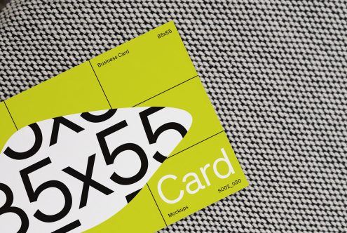 Business card mockup with bright yellow design over textured fabric perfect for showcasing branding and identity designs for creative professionals