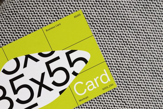 Business card mockup with bright yellow design over textured fabric perfect for showcasing branding and identity designs for creative professionals