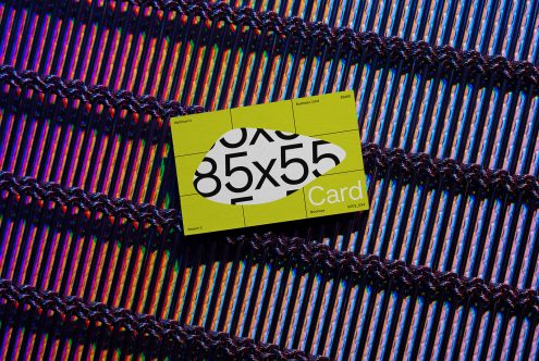 Business card mockup on textured fabric showcasing vibrant design and typography, ideal for graphic presentations and portfolio display.