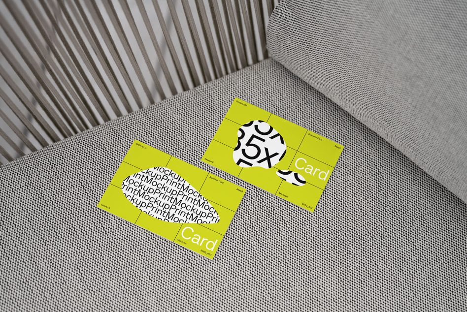 Business card mockup on textured couch with bright yellow design and bold typography, ideal for realistic presentation and portfolio display.