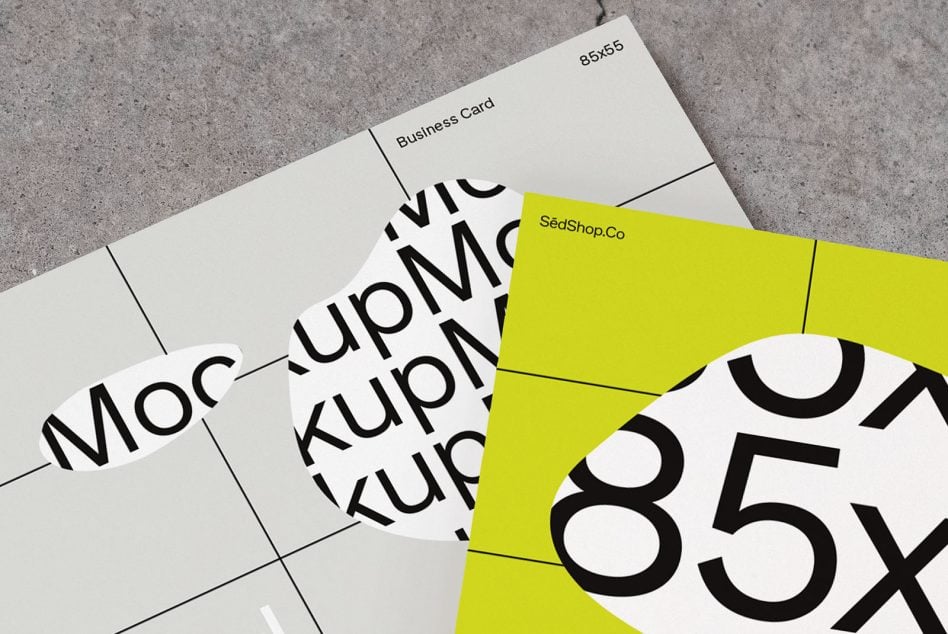 Stacked white business cards overlapping bright yellow card mockup displaying large numerals on concrete