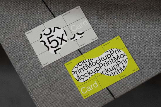 Stylish business card mockups with unique fonts and bold graphics, presented on textured grey background for design showcase.