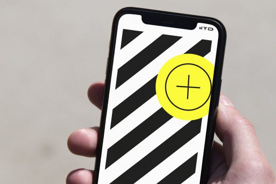 Hand holding smartphone with graphic design mockup, bold black stripes and yellow plus icon, concept for app designers.