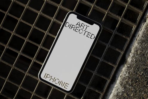 Smartphone mockup on urban metal grid, showcasing screen for app design presentation, angled view, designers template.