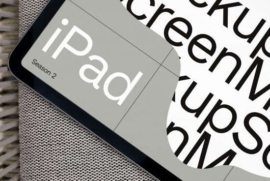 Stylish tablet mockup with a partial view of the screen showing the word iPad, ideal for app design presentations, digital asset designers.