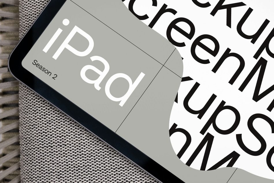 iPad screen mockup showing bold sans-serif typography overlaid on gray background