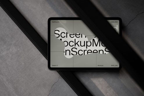 Modern tablet screen mockup on marble surface with shadow overlay for showcasing design projects, digital assets, user interface designs.