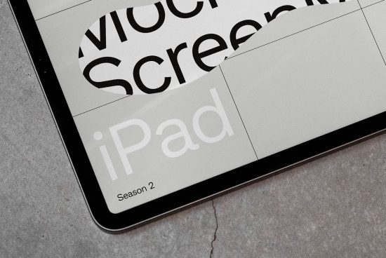 iPad mockup with a sleek design and minimalist black frame on a textured gray surface, ideal for showcasing digital app or website interfaces.