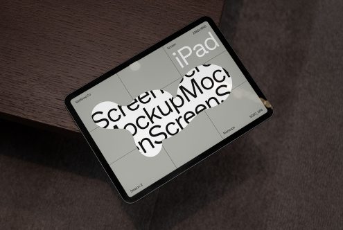 iPad screen mockup on wooden surface for digital asset design demonstrating usability, ideal for showcasing app interfaces to clients.