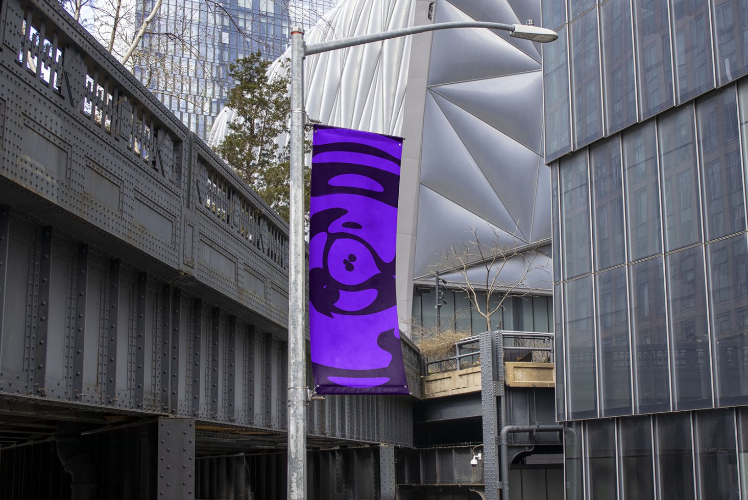 Urban street banner mockup hanging from a metal pole with a playful purple character design, showcasing outdoor advertising in a modern city setting.