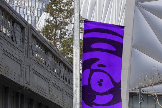 Urban banner mockup on pole with vibrant purple color and abstract design, against modern architectural background for outdoor advertising.