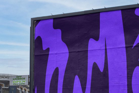 Urban billboard mockup with purple abstract graphics on a building facade for advertising design presentation.