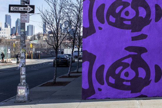Urban street scene with vivid purple graffiti wall art, city background, suitable for mockup graphics and urban design templates.