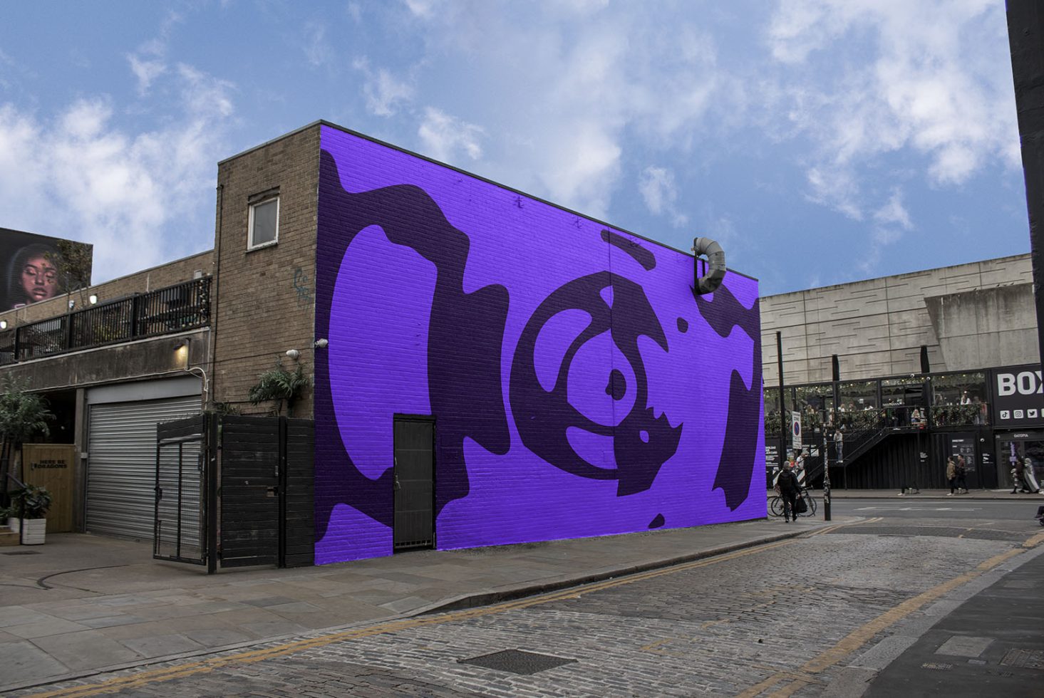 Urban street wall with vibrant purple abstract mural for mockup designs, showcasing street-art style graphics, ideal background for display.