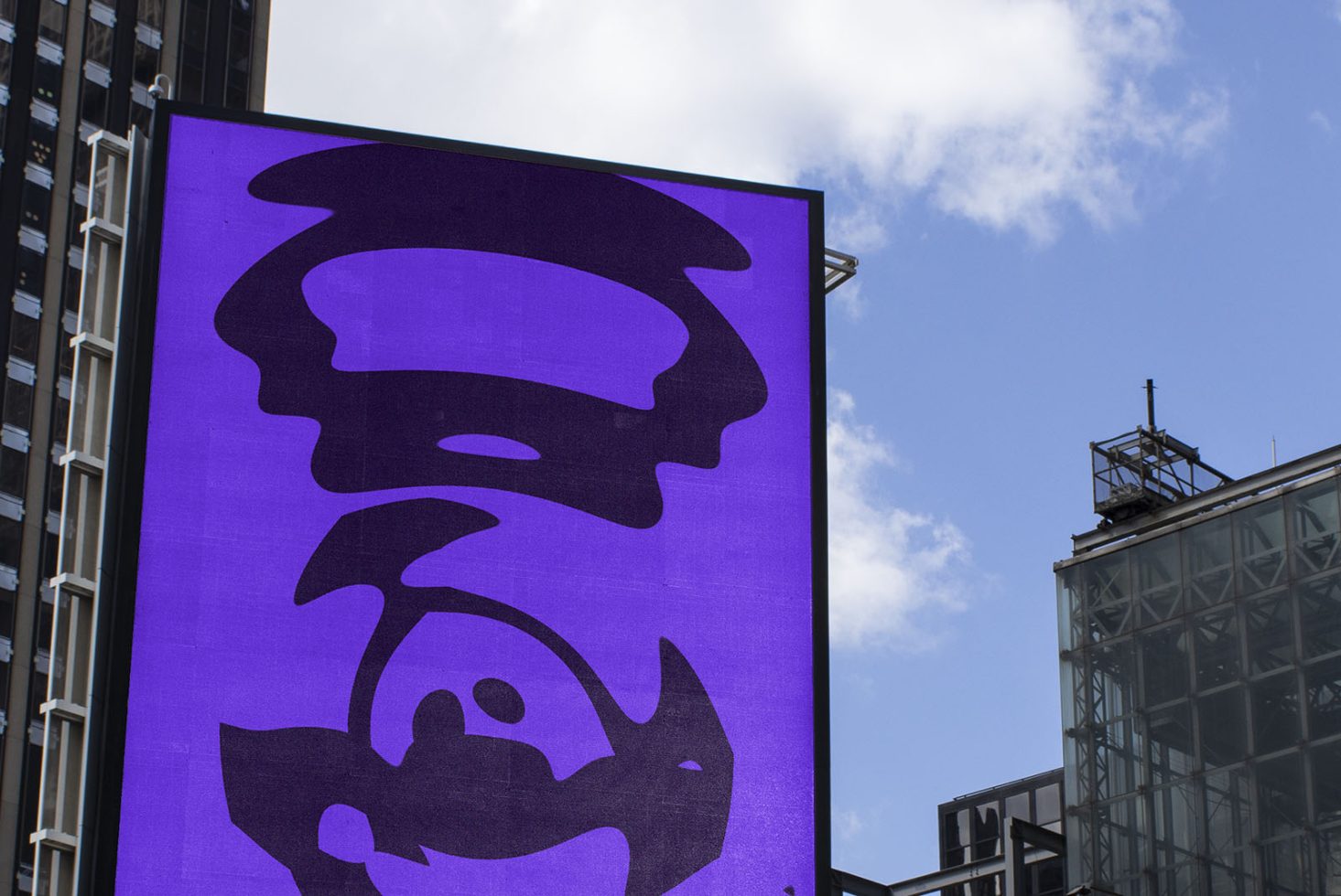 Urban billboard mockup with bold purple abstract design, against a backdrop of city skyline and clear sky, ideal for billboard advertising graphics.