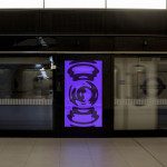 Underground station digital billboard mockup with vibrant purple graphic design ad, showcasing dynamic advertising space for designers.
