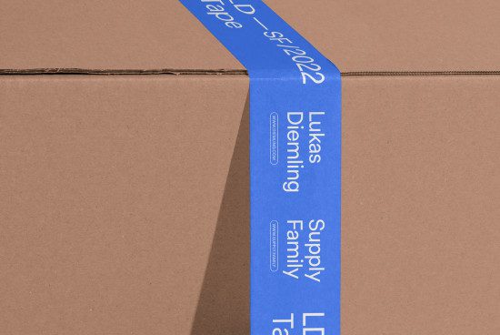 Blue adhesive tape with typography design on cardboard, mockup for branding, packaging, and logo presentation.
