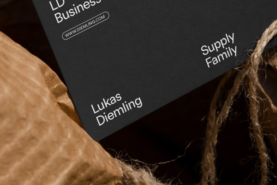 Elegant black business card mockup with white typography, textured paper background, and natural twine for graphic designers.