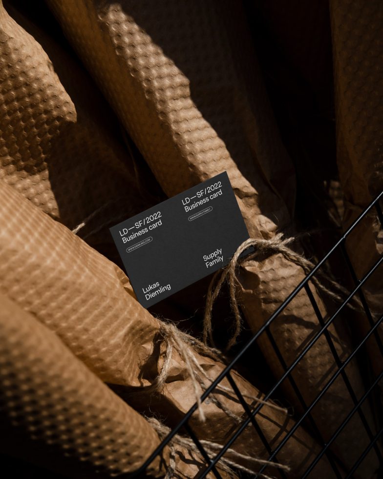 Elegant business card mockup with textured paper backdrop and natural lighting, ideal for presenting corporate identity designs to clients.