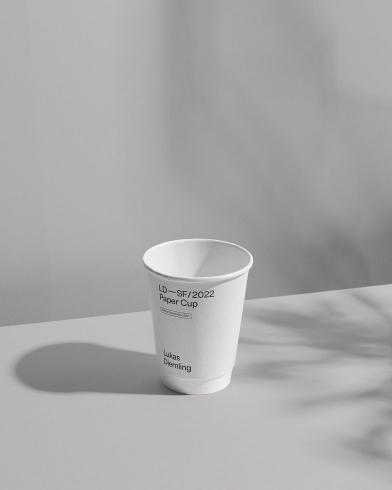 Minimalist paper cup mockup on a shadowed background for brand presentation, product design showcasing, clean and modern, designers asset.