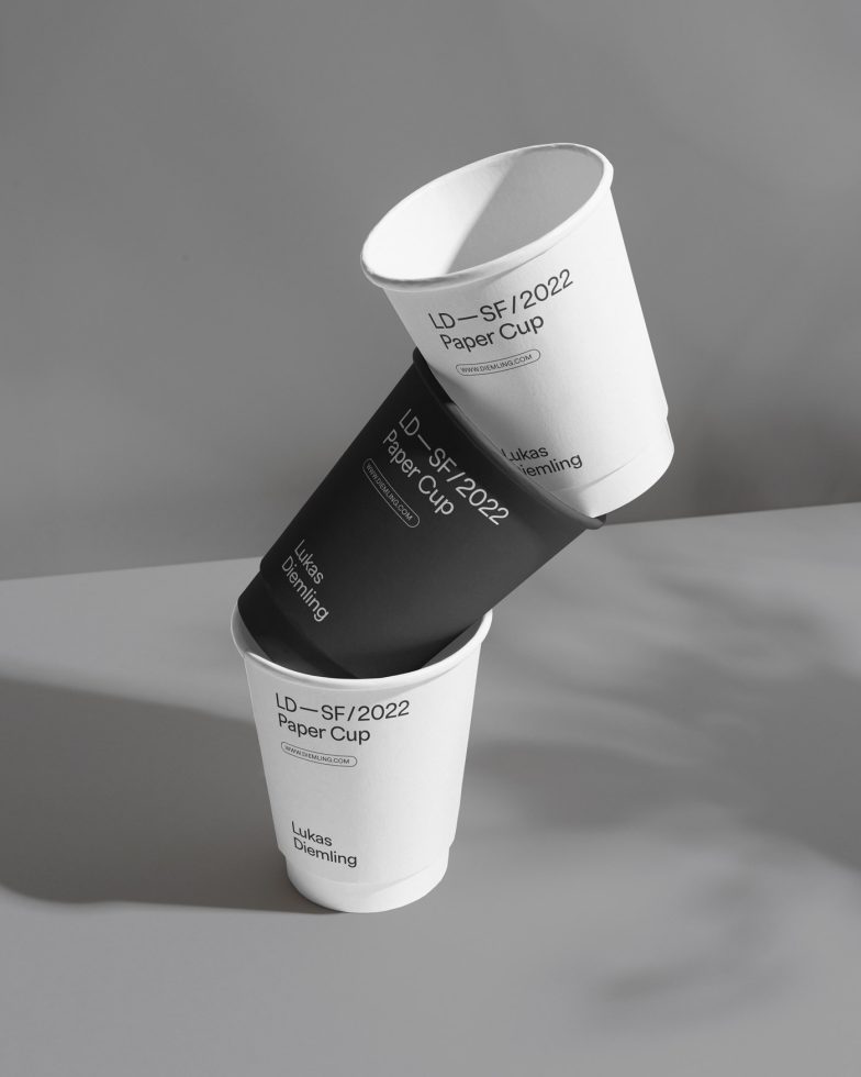 Elegant paper cup mockup with dynamic shadow, showcasing design space for branding, modern product presentation, ideal for designers' portfolios.